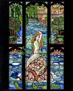 a stained glass window with a mermaid on it