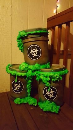 three buckets with green pom poms on them