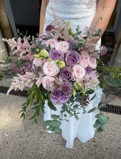 a bride holding a bouquet of flowers in her hands