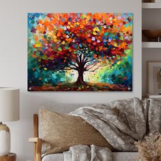 a living room with a couch and painting on the wall above it that has an abstract tree