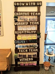 a wooden sign that says grow with us, creative team, worship team, hospitality, children & youth, tech team, wine