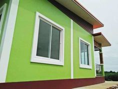 a green house with white trim and windows