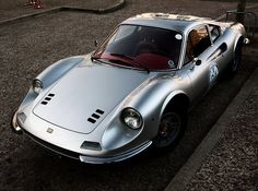 a silver sports car is parked on the street