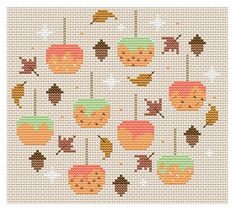 a cross stitch pattern with autumn leaves and acorns