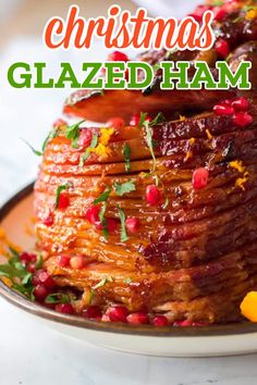 christmas glazed ham on a plate with pomegranates and orange zest