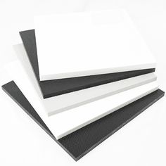 four white and black foam sheets stacked on top of each other