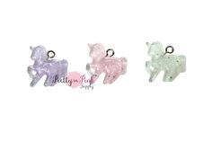 three little pony charms sitting next to each other