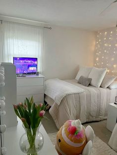 a bedroom with a bed, desk and television