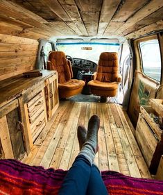 the inside of a van with two chairs and a couch in it's center