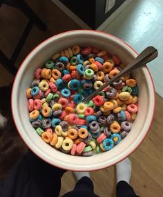 a person holding a bowl full of cereal