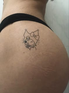 a woman's back with a tattoo on her stomach that has an image of a cat