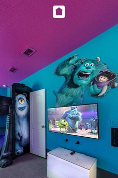 a bedroom with monsters painted on the walls and two televisions mounted to the wall