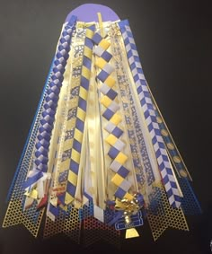 a blue and white clock with gold trimmings on it's face next to a bell