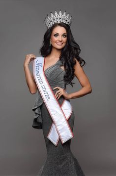 a woman in a dress and tiara posing for a photo with her hand on her hip