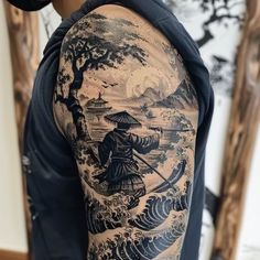 a man with a japanese tattoo on his arm