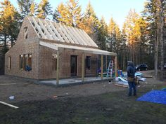 a man standing in front of a house under construction