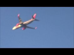 an airplane is flying in the sky with pink tail tips on it's wings