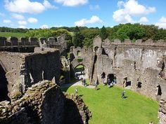 an aerial view of the inside of a castle with people walking around and looking at it