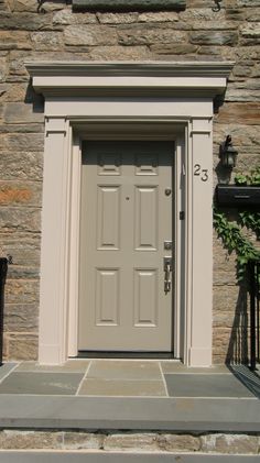 the front door to a house with stone steps