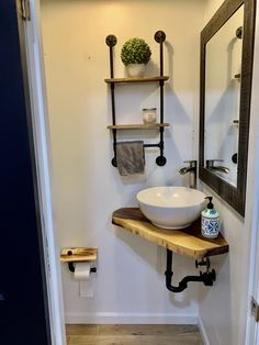 a bathroom with a sink and shelves on the wall