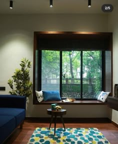 a living room filled with furniture and a large window