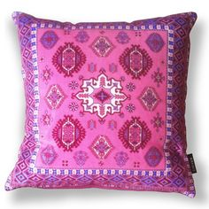 a pink pillow with an intricate design on it