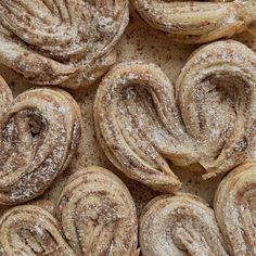 several pastries are covered with powdered sugar