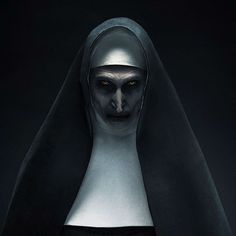 the nun from scream movie is shown in this dark background with an evil look on her face