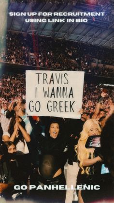 a group of people holding up signs in front of a crowd at a sporting event