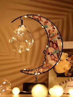 a lamp that is sitting on top of a table next to some pictures and lights