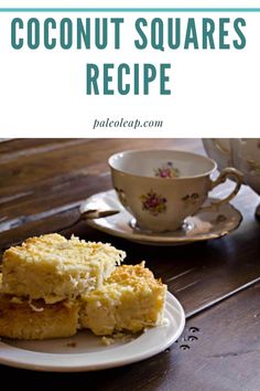 two pieces of coconut squares on a plate with a cup and saucer in the background