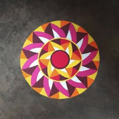 a colorful circular design on the ground