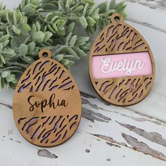 two personalized wooden ornaments sitting next to each other