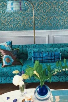 a living room filled with blue couches and pillows