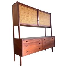 a wooden dresser with bamboo doors and drawers on it's side, against a white background