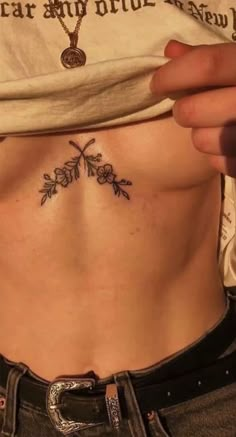 a woman with a cross tattoo on her stomach