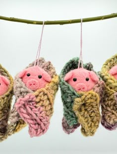 three knitted pigs hanging from a clothes line