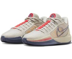 the nike zoom basketball shoe is shown in white and blue, with red accents on the upper