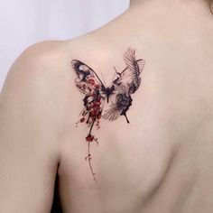 a woman with a butterfly tattoo on her back