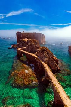 an aerial view of the ocean and castle