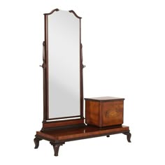 an antique wooden dressing table with mirror and chest on it's side, against a white background