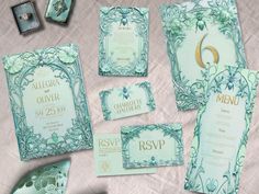 an assortment of wedding stationery items on a table