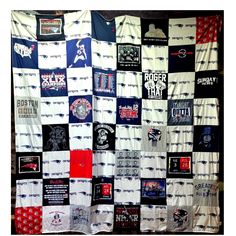 a quilt made up of t - shirts is hanging on the wall