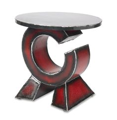 a red and silver sculpture sitting on top of a table