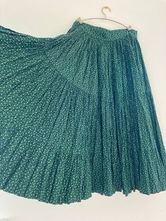 This is beautiful long pleated skirt has 3 tiered. Small flower print *There is a small hole next to the hook ( its hidden when  it close the hook) *One of the hooks is missing. waist   : 13inch (taken in flat) length : 27.5inch Pleated Tiered Maxi Skirt, Green Ruffled Full Maxi Skirt, Accordion Pleats Tiered Skirt, Green Flowy Tiered Pleated Skirt, Vintage Tiered Skirt With Floral Print, Spring Tiered Maxi Skirt With Accordion Pleats, Casual Green Tiered Skirt, Vintage Green Tiered Skirt, Fitted Tiered Pleated Skirt