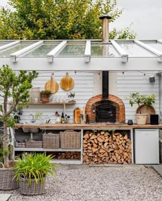 an outdoor kitchen with wood stacked on the counter