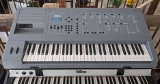 an electronic keyboard sitting on top of a table