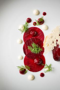 beets and cheese are on a white plate with garnishes around them