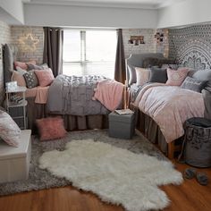 a bed room with a neatly made bed next to a window and a rug on the floor