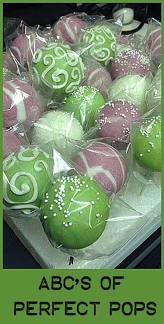 there are many green and pink decorated balls in the box with words abc's of perfect pops